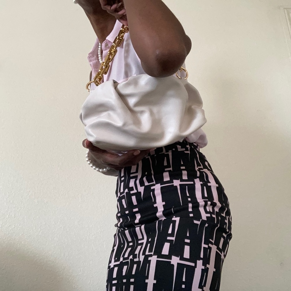 Elegant vegan leather clutch bag with gold chain.